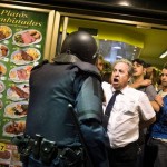 Garçom herói protege o povo contra a repressão policial na Espanha
